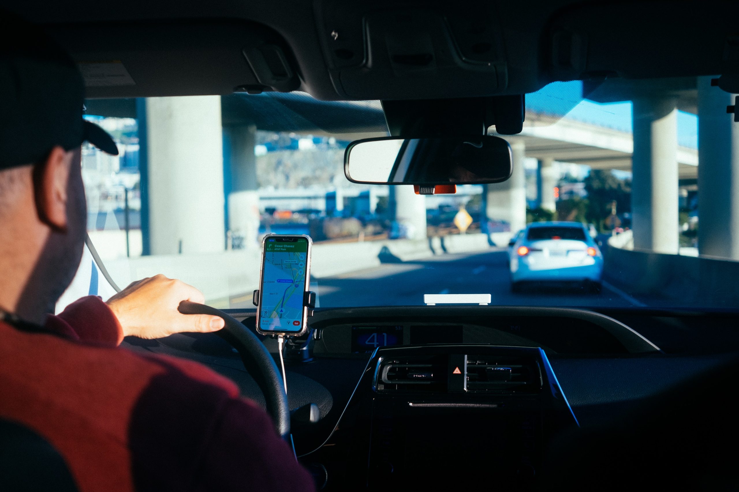 A professional driver looking at directions on a mobile screen